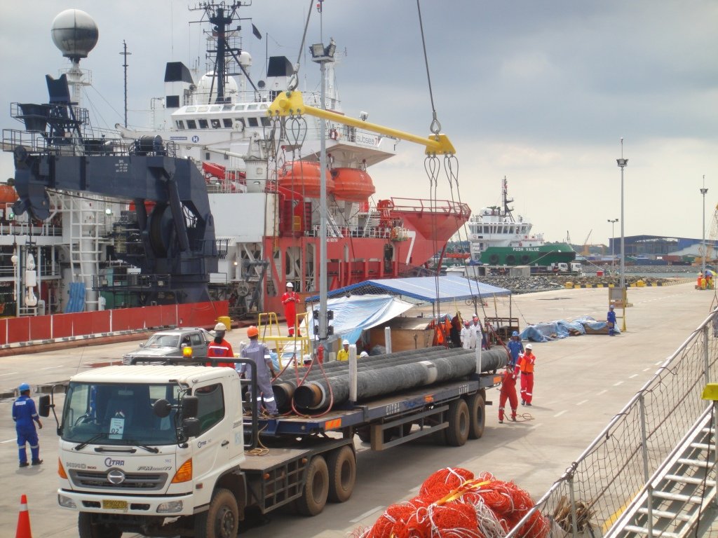 Pipe cargo being loaded at port
